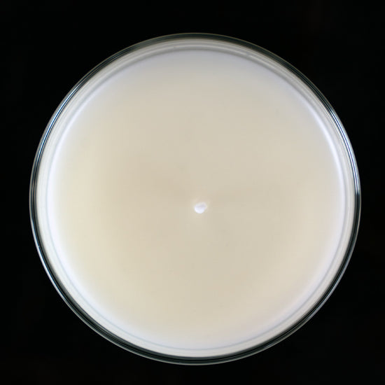 A top down view of a beautiful smooth surface on a paraffin candle. Paraffin, home made candle.