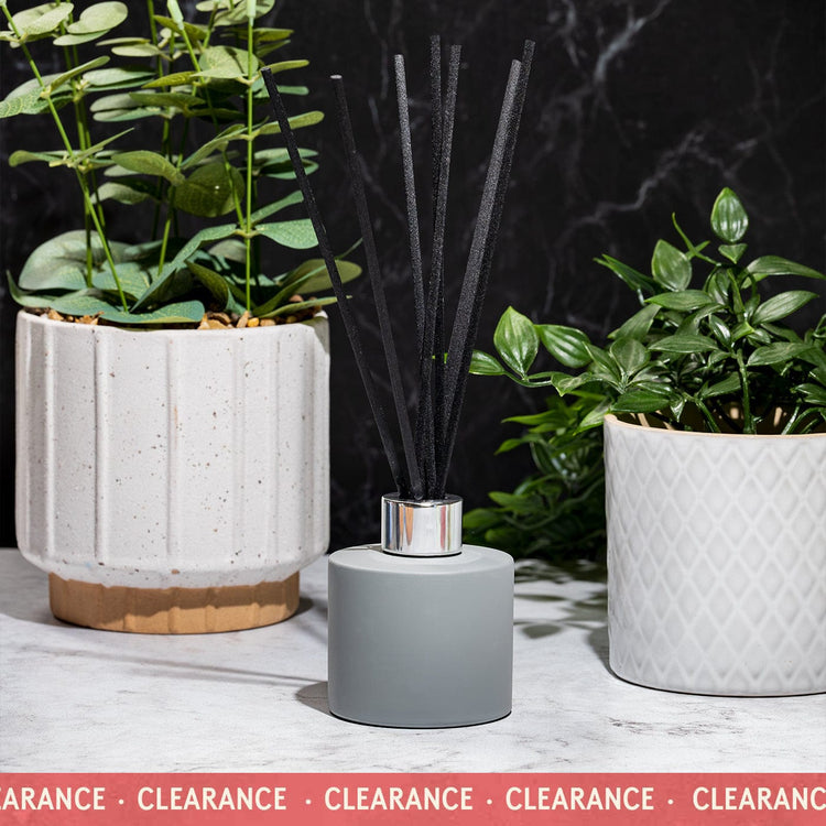 Matt grey 100ml diffuser on white marble with plants in pots