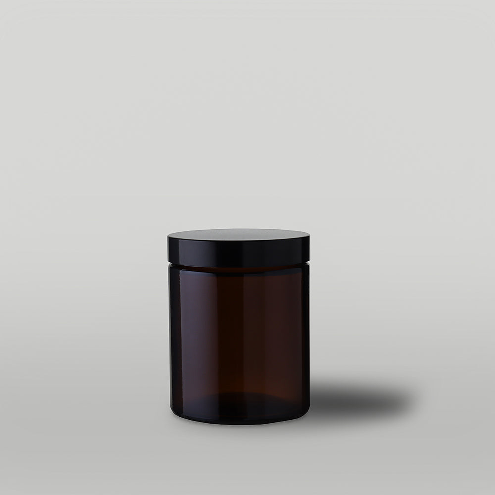 15cl amber Apothecary style candle jar with lid on a grey background