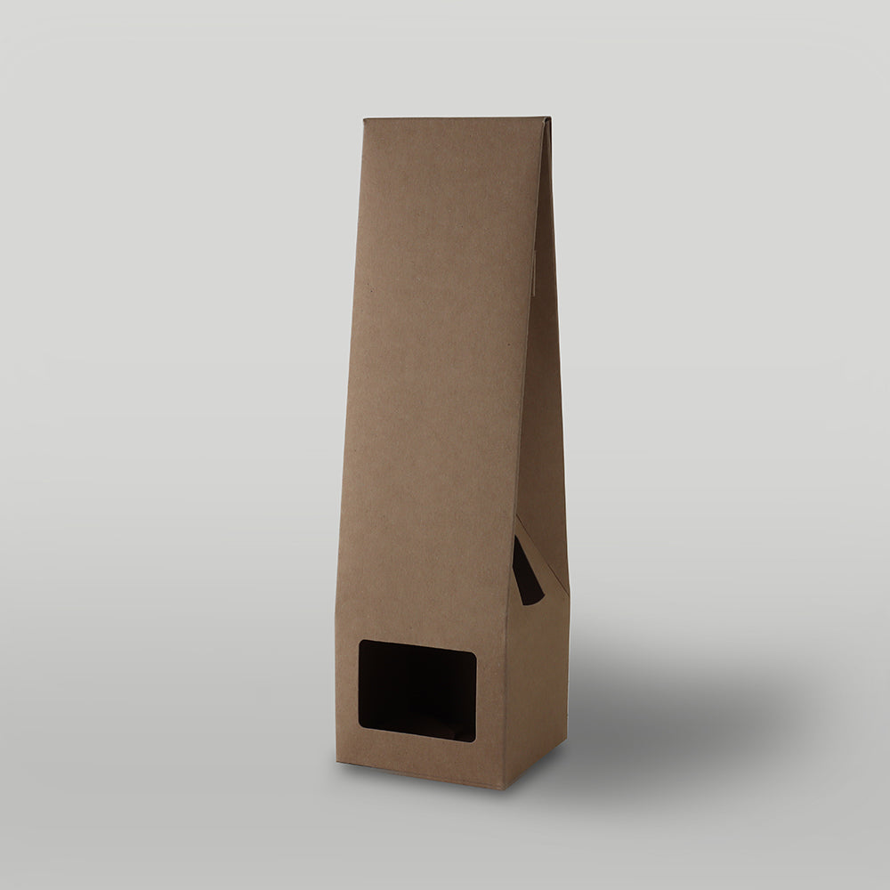 Brown candle packaging on a light grey background