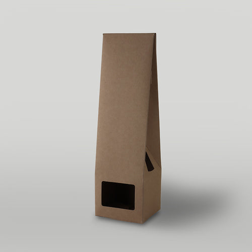 Brown candle packaging on a light grey background