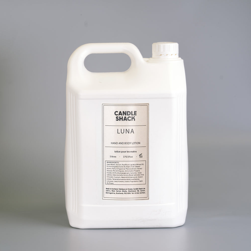 Large white container of 'Luna' hand and body lotion from Candle Shack on a gray background