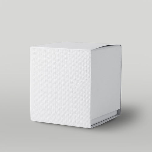 White textured candle box on a light grey background
