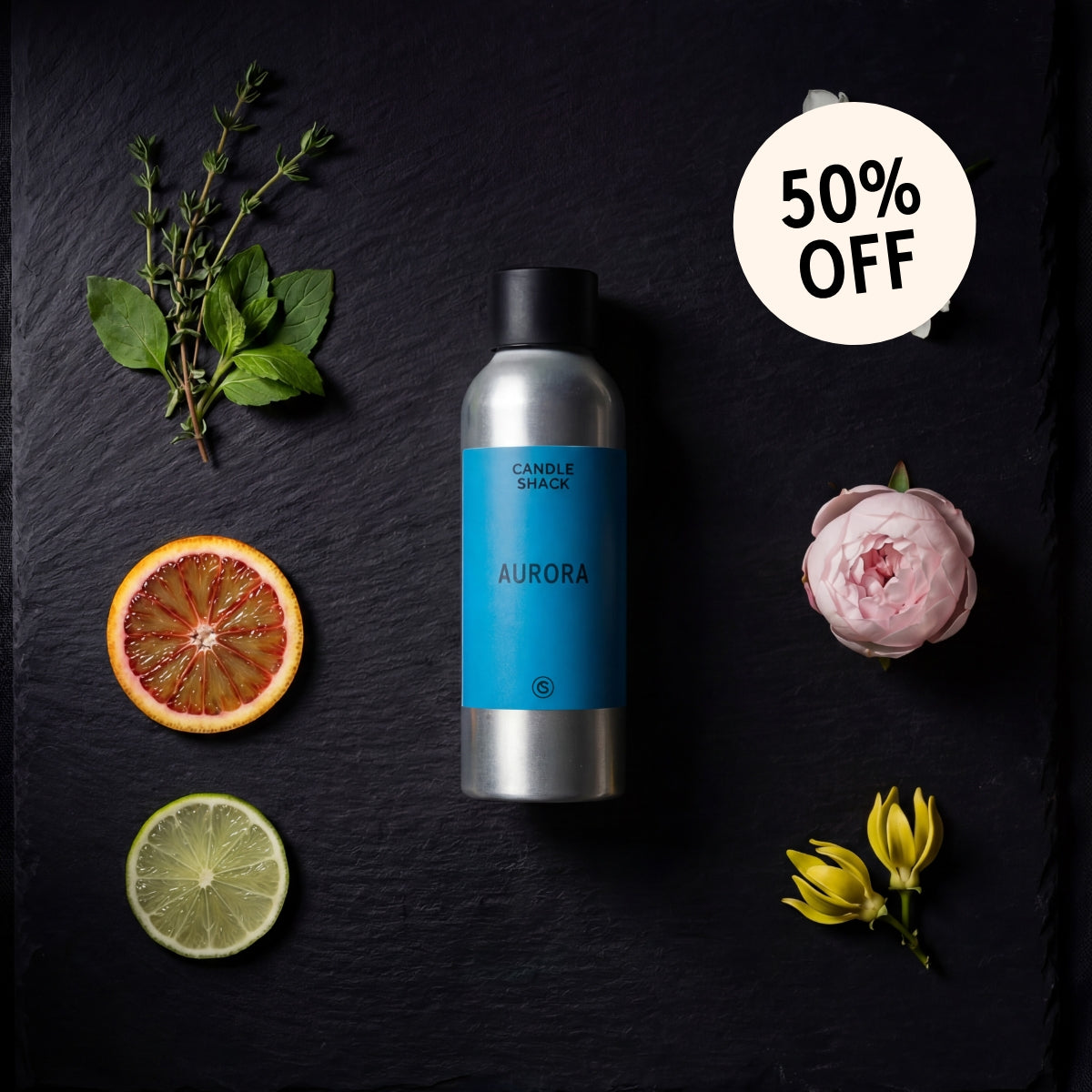 Aurora fragrance oil on a dark surface with fruits and flowers, featuring a 50% off badge.