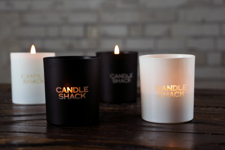 Group of candles with laser cut candle shack logo on them. Natural wax container candles. Candle making. Home made candles.