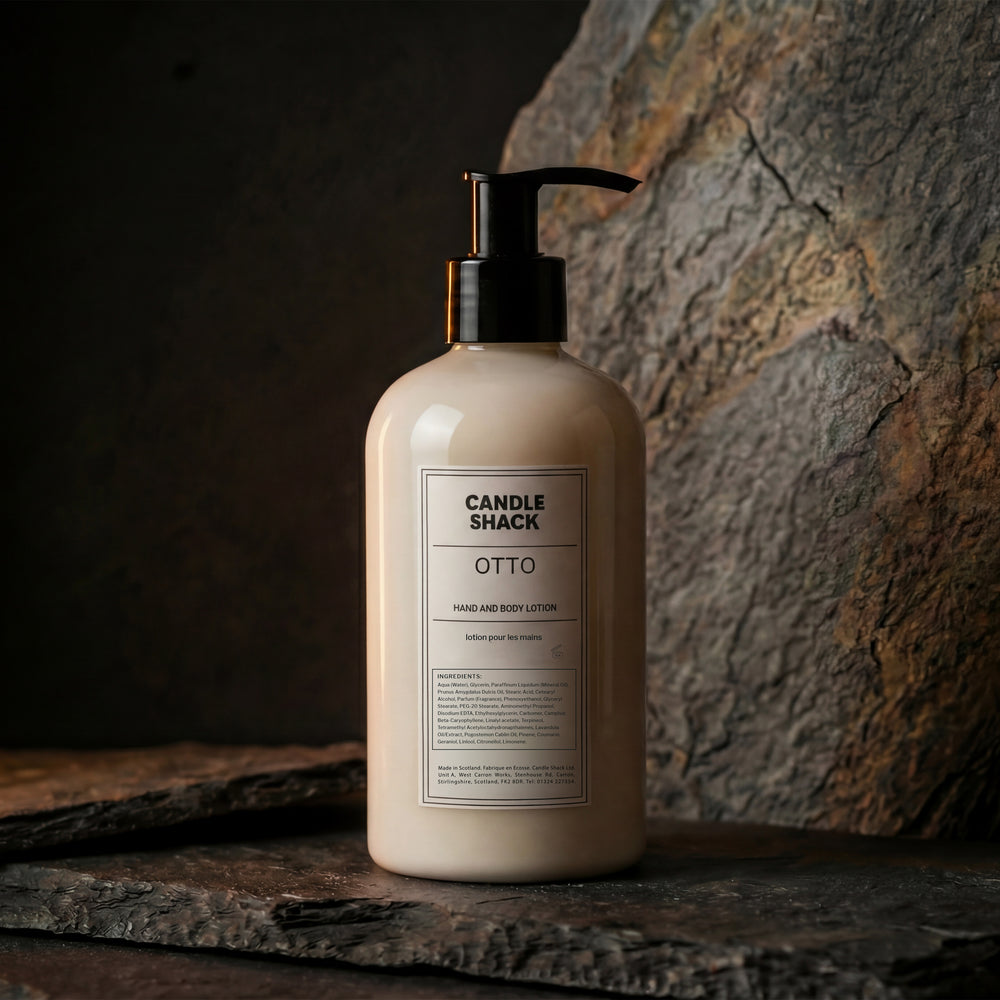 Lotion bottle labeled 'Candle Shack Luna' on a stone surface with a dark background