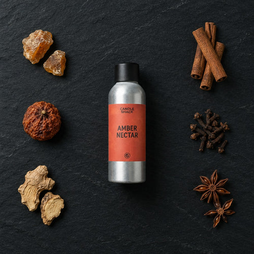 Amber Nectar fragrance oil - Candle Shack aluminium bottle with dried botanicals on a dark slate background