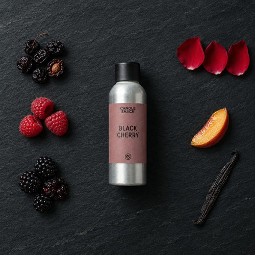 Black Cherry fragrance oil - Candle Shack aluminium bottle with dried botanicals on a dark slate background