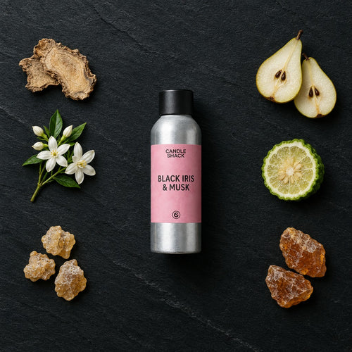 Black Iris & Musk fragrance oil - Candle Shack aluminium bottle with dried botanicals on a dark slate background