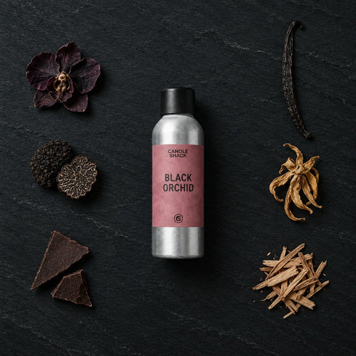 Black Orchid fragrance oil - Candle Shack aluminium bottle with dried botanicals on a dark slate background