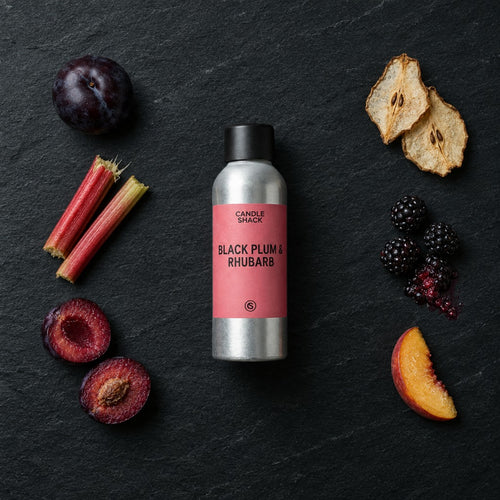 Black Plum & Rhubarb fragrance oil - Candle Shack aluminium bottle with dried botanicals on a dark slate background