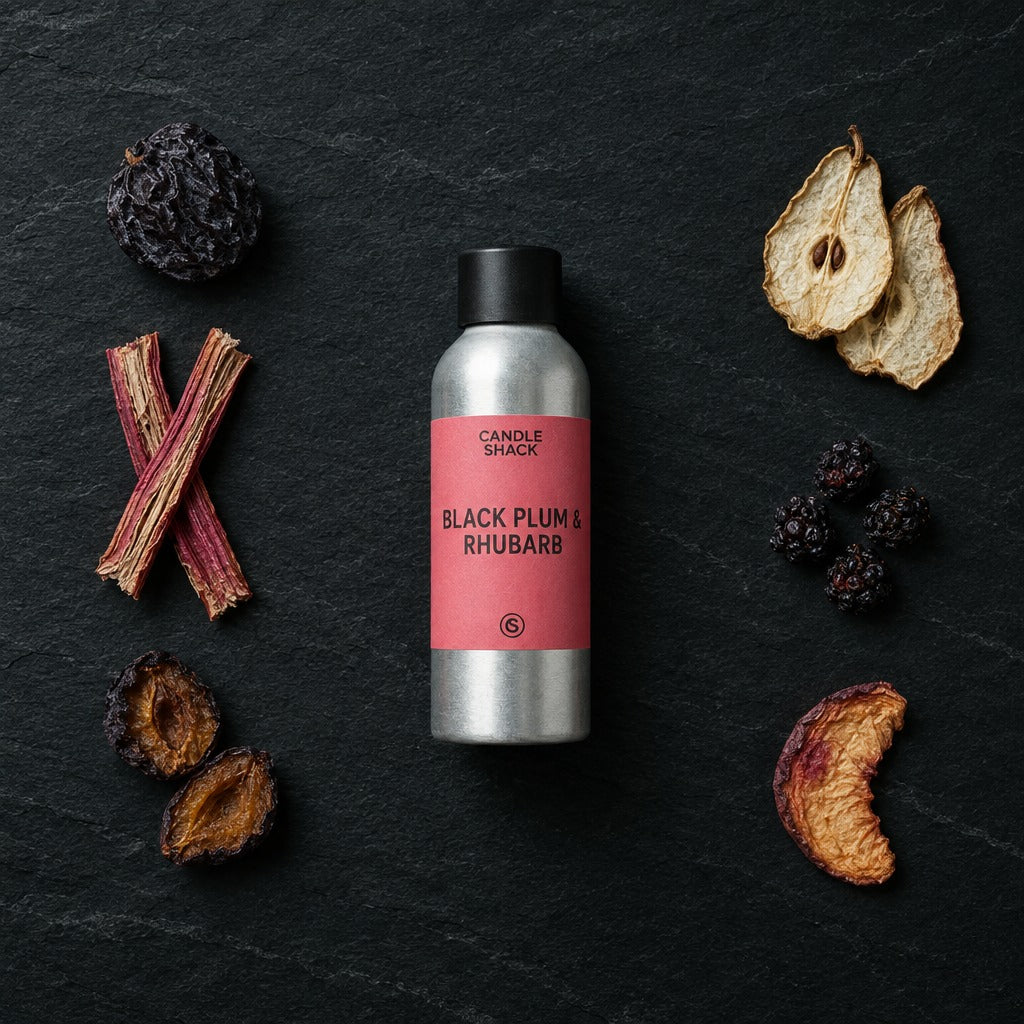Black Plum & Rhubarb fragrance oil - Candle Shack aluminium bottle with dried botanicals on a dark slate background