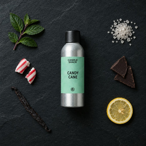 Candy Cane fragrance oil - Candle Shack aluminium bottle with dried botanicals on a dark slate background