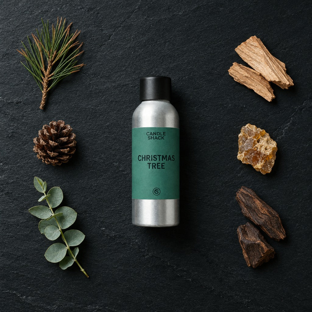 Christmas Tree fragrance oil - Candle Shack aluminium bottle with dried botanicals on a dark slate background