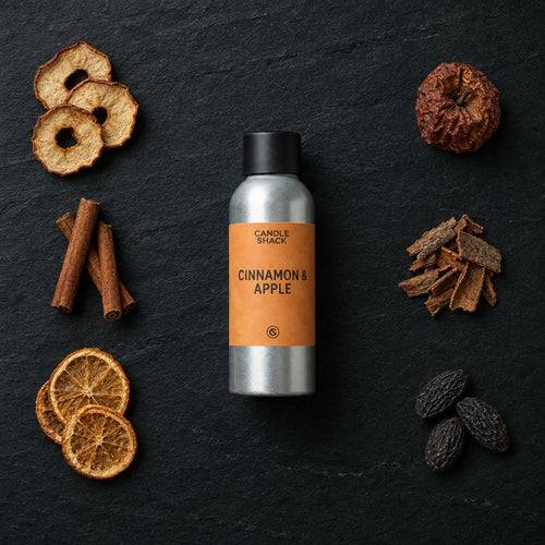 Cinnamon and Apple fragrance oil - Candle Shack aluminium bottle with dried botanicals on a dark slate background