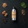 Creamy Musk and Sandalwood fragrance oil - Candle Shack aluminium bottle with dried botanicals on a dark slate background