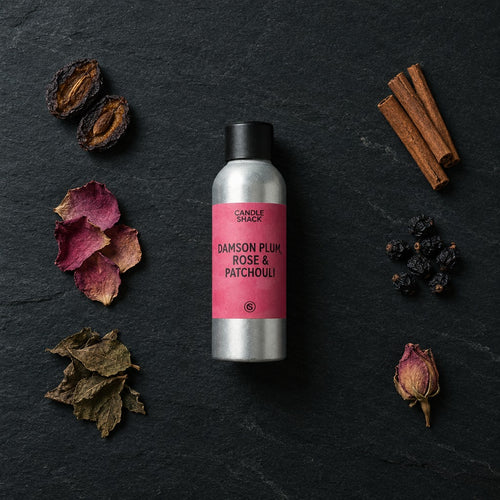 Damson Plum, Rose & Patchouli fragrance oil - Candle Shack aluminium bottle with dried botanicals on a dark slate background