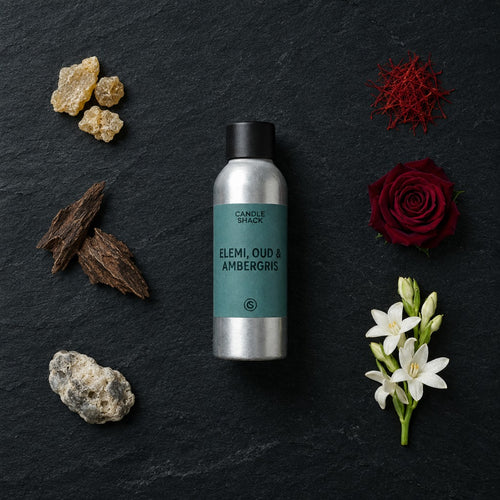 Elemi, Oud & Ambergris fragrance oil - Candle Shack aluminium bottle with dried botanicals on a dark slate background