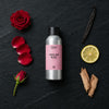 English Rose fragrance oil - Candle Shack aluminium bottle with dried botanicals on a dark slate background