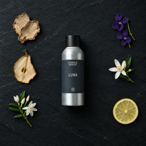 Luna fragrance oil - Candle Shack aluminium bottle with dried botanicals on a dark slate background