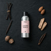 Luscious Vanilla fragrance oil - Candle Shack aluminium bottle with dried botanicals on a dark slate background