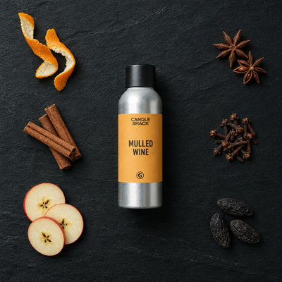 Mulled Wine fragrance oil - Candle Shack aluminium bottle with dried botanicals on a dark slate background