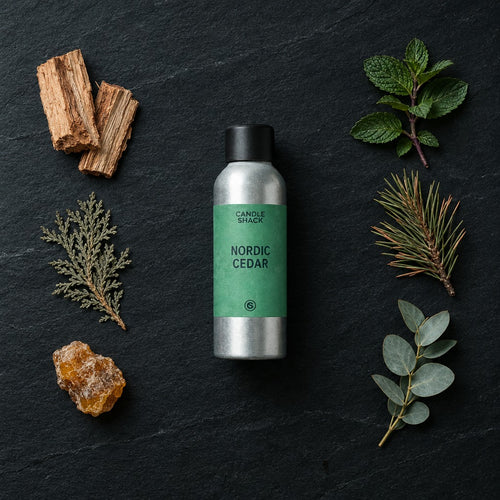 Nordic Cedar fragrance oil - Candle Shack aluminium bottle with dried botanicals on a dark slate background