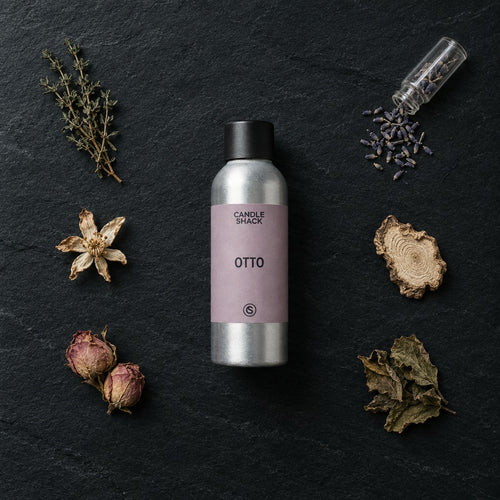 Otto fragrance oil - Candle Shack aluminium bottle with dried botanicals on a dark slate background