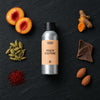 Peach Couture fragrance oil - Candle Shack aluminium bottle with dried botanicals on a dark slate background