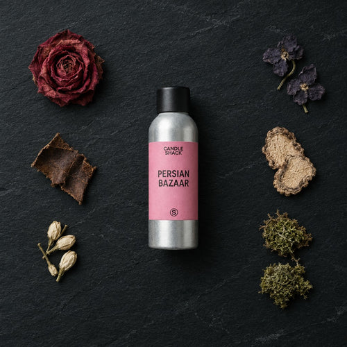 Persian Bazaar fragrance oil - Candle Shack aluminium bottle with dried botanicals on a dark slate background