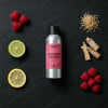 Raspberry Daiquiri fragrance oil - Candle Shack aluminium bottle with dried botanicals on a dark slate background