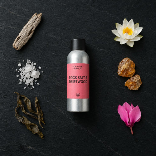 Rock Salt & Driftwood fragrance oil - Candle Shack aluminium bottle with dried botanicals on a dark slate background