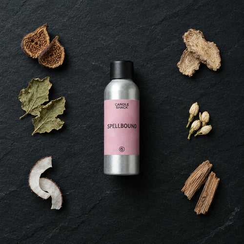 Spellbound fragrance oil - Candle Shack aluminium bottle with dried botanicals on a dark slate background
