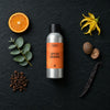 Spiced Orange fragrance oil - Candle Shack aluminium bottle with dried botanicals on a dark slate background