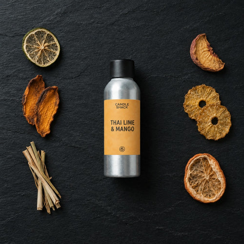 Thai Lime & Mango fragrance oil - Candle Shack aluminium bottle with dried botanicals on a dark slate background