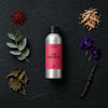 The Emperor fragrance oil - Candle Shack aluminium bottle with dried botanicals on a dark slate background