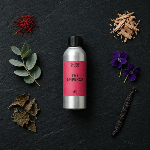 The Emperor fragrance oil - Candle Shack aluminium bottle with dried botanicals on a dark slate background