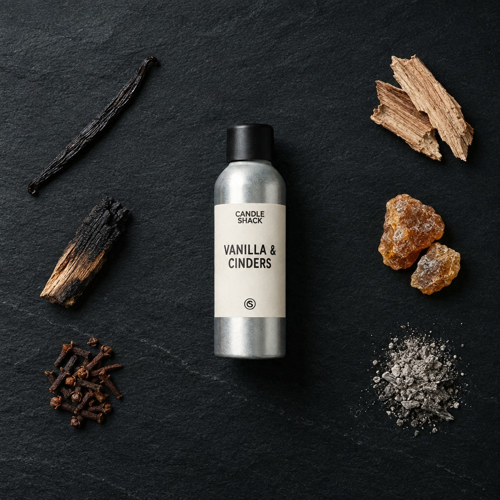 Vanilla & Cinders fragrance oil - Candle Shack aluminium bottle with dried botanicals on a dark slate background