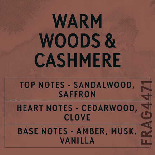 Warm Woods & Cashmere fragrance oil - Candle Shack aluminium bottle with dried botanicals on a dark slate background