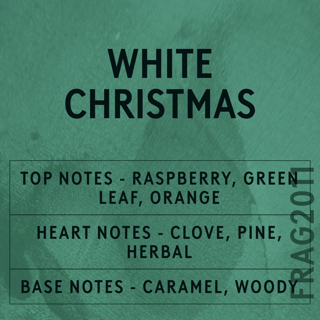 White Christmas fragrance oil - Candle Shack aluminium bottle with dried botanicals on a dark slate background