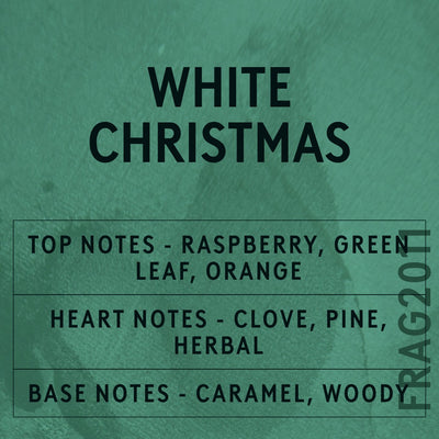 White Christmas fragrance oil - Candle Shack aluminium bottle with dried botanicals on a dark slate background