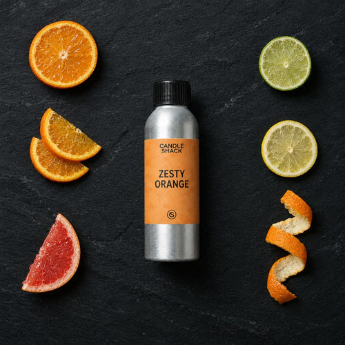 Zesty Orange fragrance oil - Candle Shack aluminium bottle with dried botanicals on a dark slate background