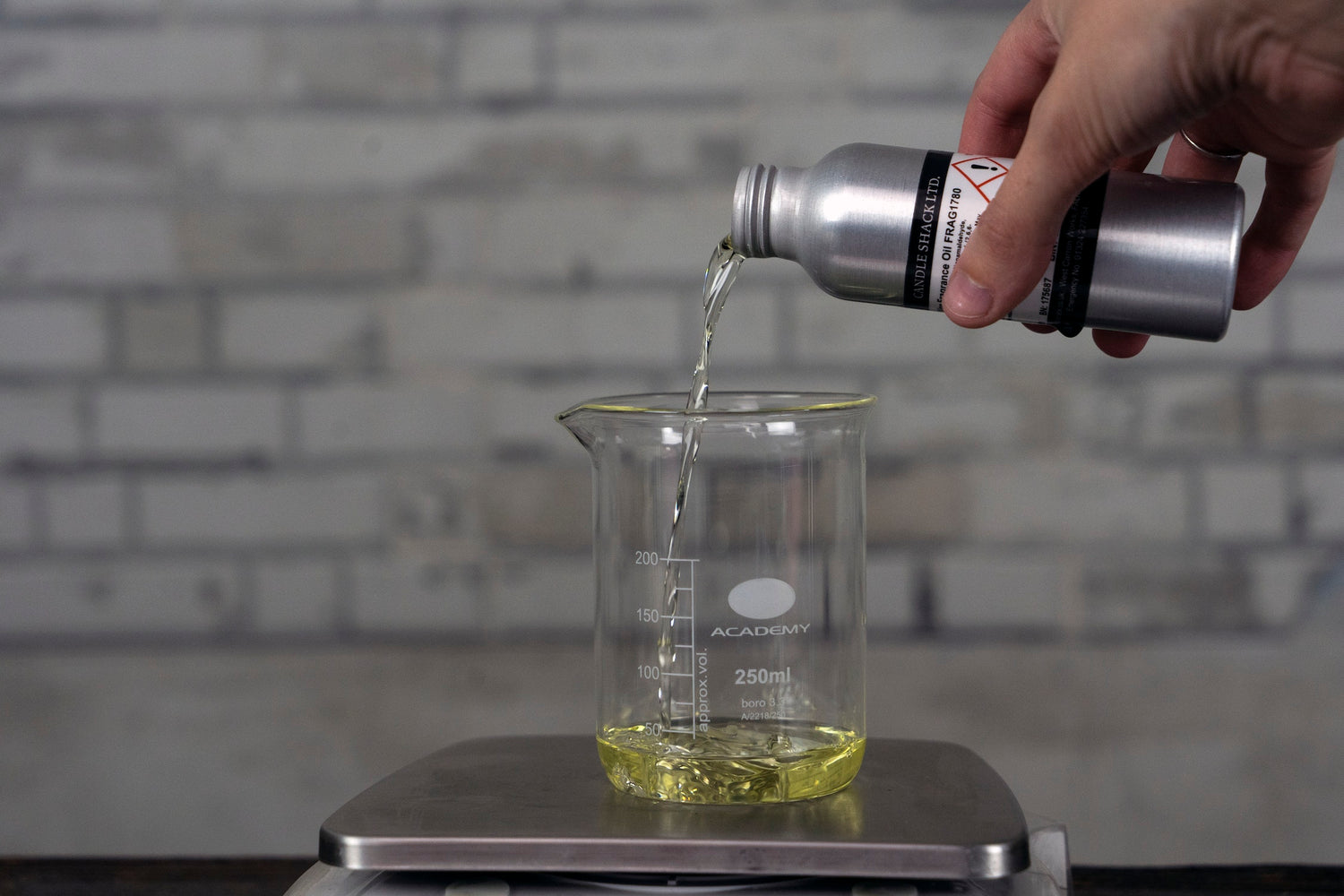 Pouring fragrance oil into a beaker on a scale. Fragrance, Diffuser oil, DIY diffuser