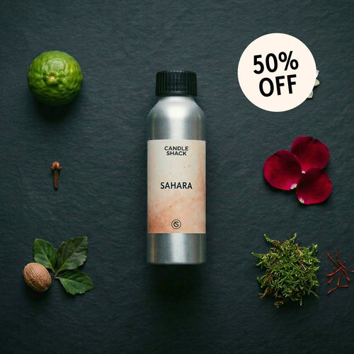 Candle Shack Sahara fragrance oil on a dark surface with natural elements and a 50% off label.