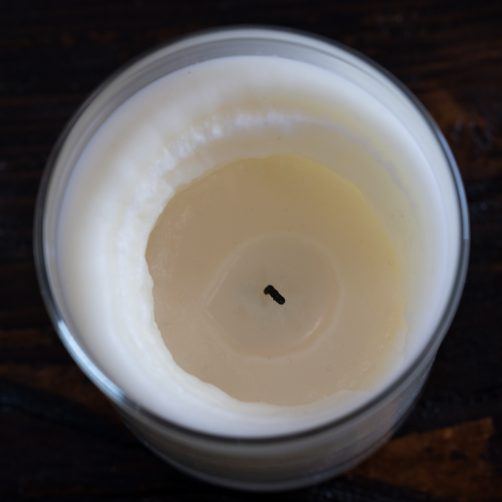 Tunneling candle with hollowed center burning on a tabletop