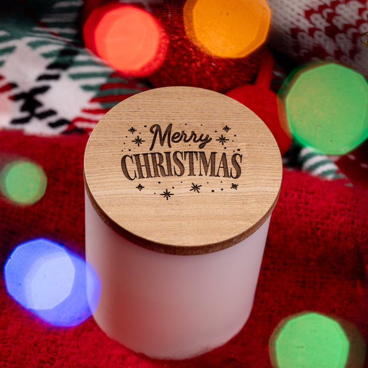 White candle with a wooden Merry Christmas wooden lid.